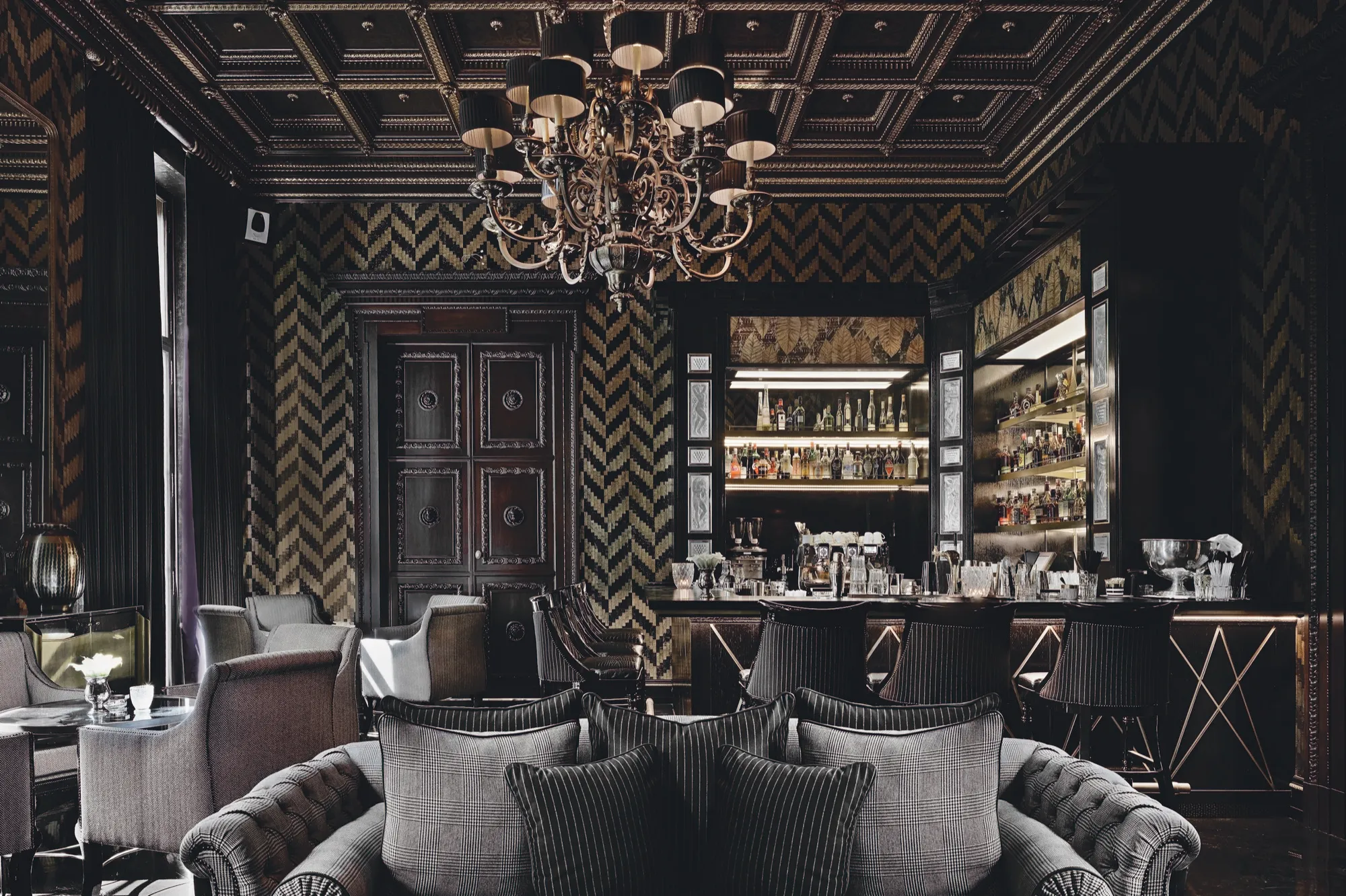 بار فندق Schlosshotel Grunewald بجدار شيفرون بالأخضر والأسود، سقف بكاسيتات وثريا